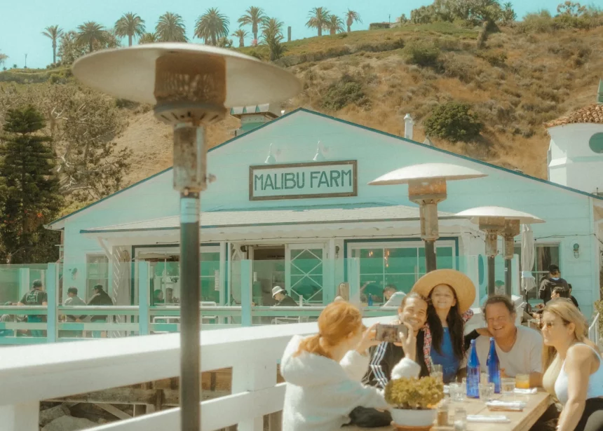 couple and family picture infront of malibu cafe